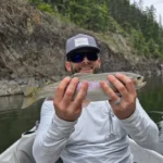 Austin Lewis, founder of GuidedFloats, with a rainbow trout