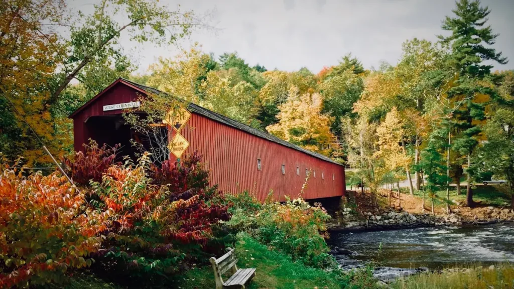 A weathered shack on the bank of a New England stream in autumn