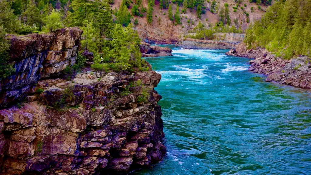 A turquoise river cutting through a rocky gorge in the mountain West