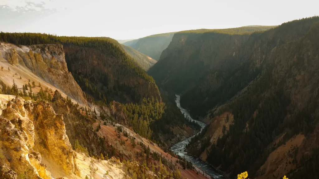 A river winding through a deep canyon at sunset in the mountain West