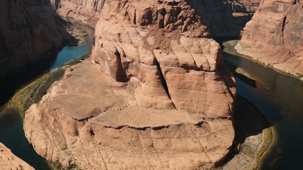 The Colorado River curving below sandstone walls at Horseshoe Bend, Arizona
